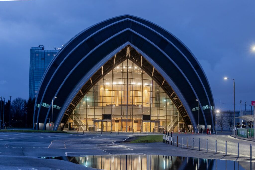 Illuminated SEC Armadillo in Glasgow, Scotland displaying its iconic curves under night skies.